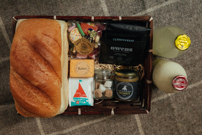 Gift basket with bread, honey, coffee and other items
